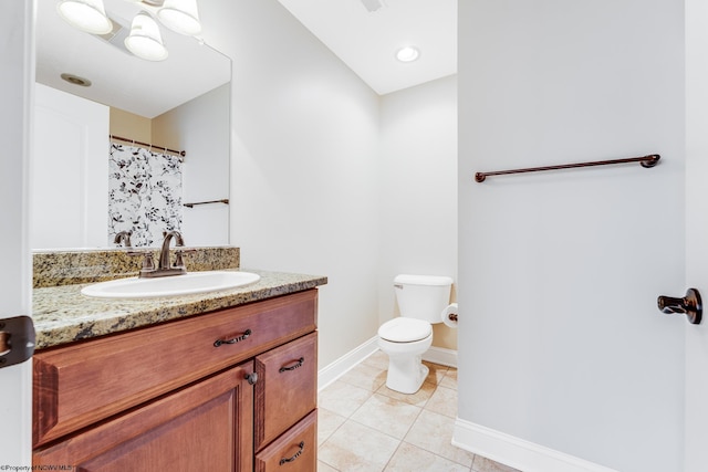 bathroom featuring vanity, toilet, and tile patterned floors