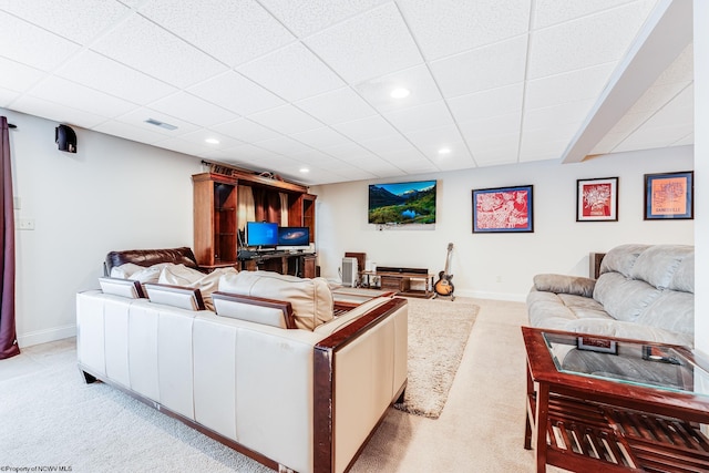 living room with light carpet and a drop ceiling