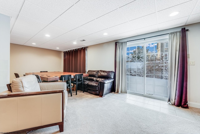 living room with light carpet and a drop ceiling