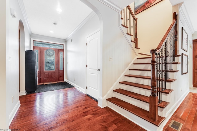 entryway featuring crown molding and dark hardwood / wood-style floors