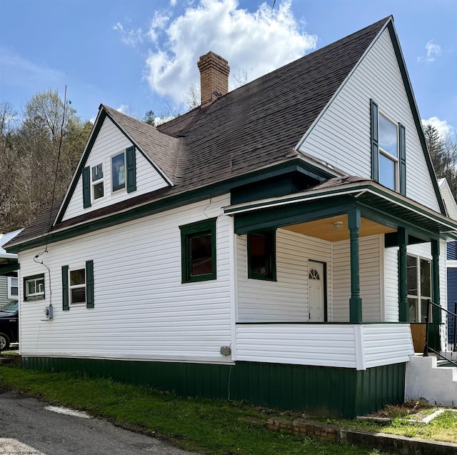 309 E Main St, Mannington, WV 26575 - view of side of home featuring a porch and a chimney
