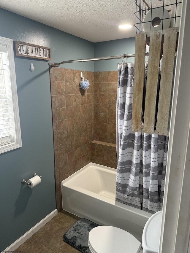 bathroom featuring a wealth of natural light, shower / tub combo with curtain, a textured ceiling, and toilet