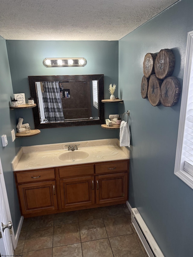 bathroom featuring vanity, a baseboard radiator, tile patterned floors, and a textured ceiling