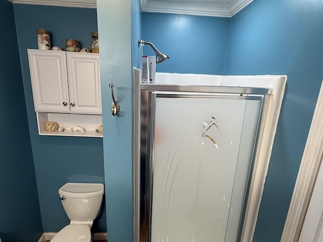 bathroom with ornamental molding and toilet