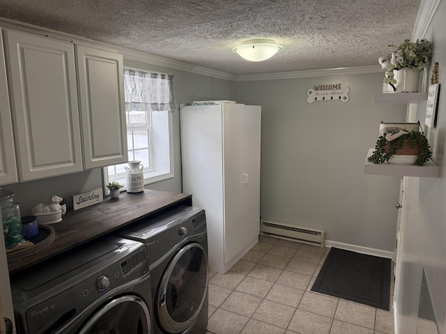 laundry room featuring light tile patterned floors, baseboard heating, cabinets, washer and dryer, and a textured ceiling