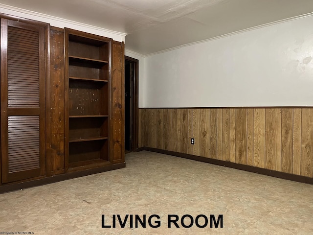 interior space featuring built in shelves and wooden walls