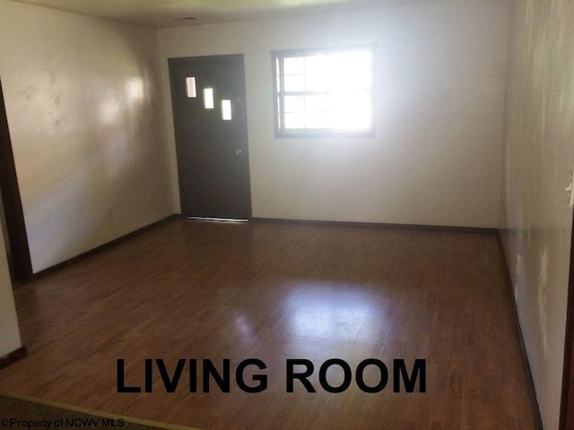 unfurnished room featuring dark hardwood / wood-style flooring