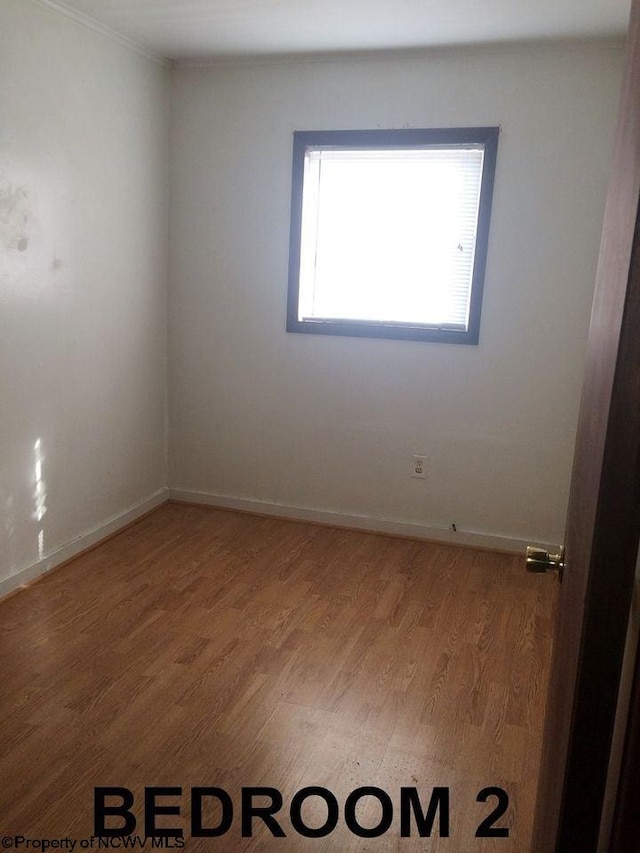 empty room with hardwood / wood-style flooring