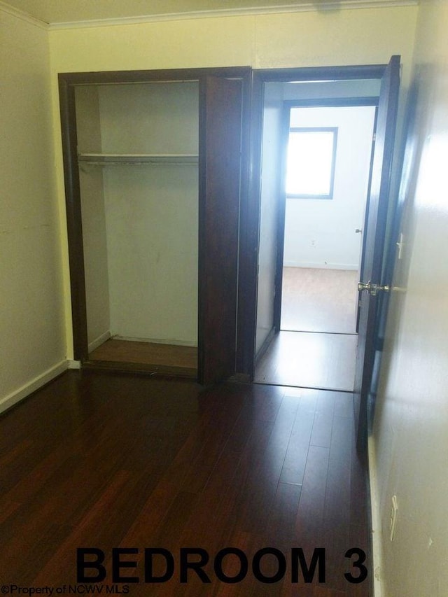 hall featuring ornamental molding and dark hardwood / wood-style floors