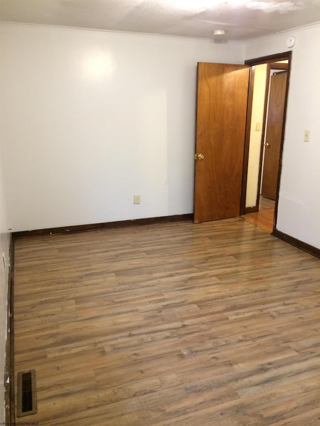 unfurnished room featuring hardwood / wood-style flooring