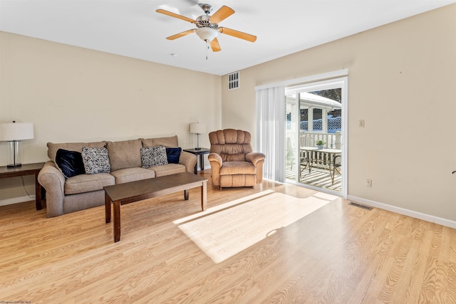 living room with ceiling fan and light hardwood / wood-style floors