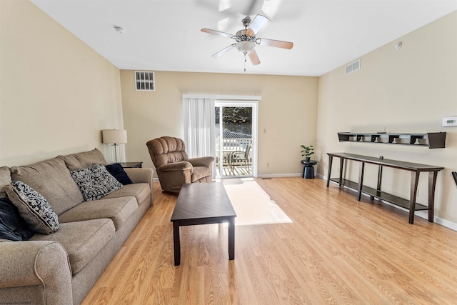 living room with ceiling fan and light hardwood / wood-style flooring