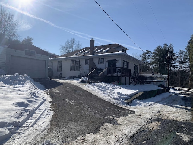 view of front of house featuring a garage and a wooden deck