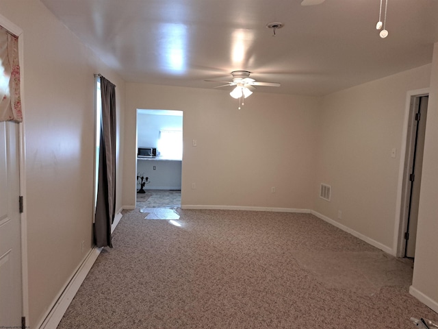 unfurnished room with visible vents, baseboards, light colored carpet, and a ceiling fan