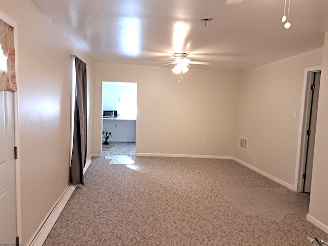 spare room with baseboards, light colored carpet, visible vents, and ceiling fan