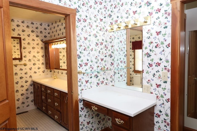 bathroom featuring tile patterned floors, vanity, and toilet