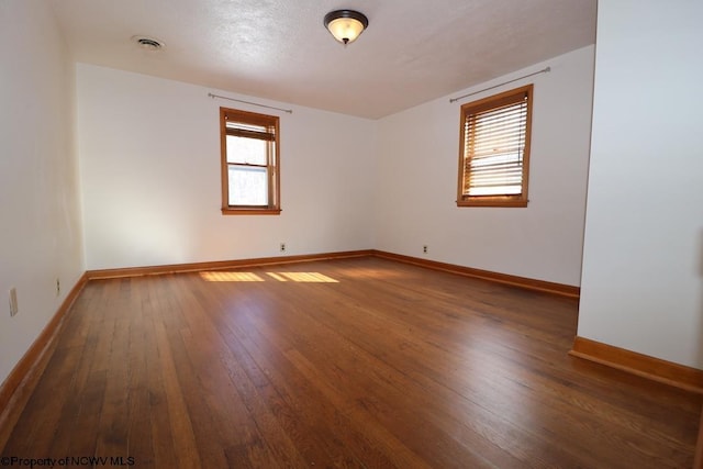 spare room featuring dark hardwood / wood-style floors