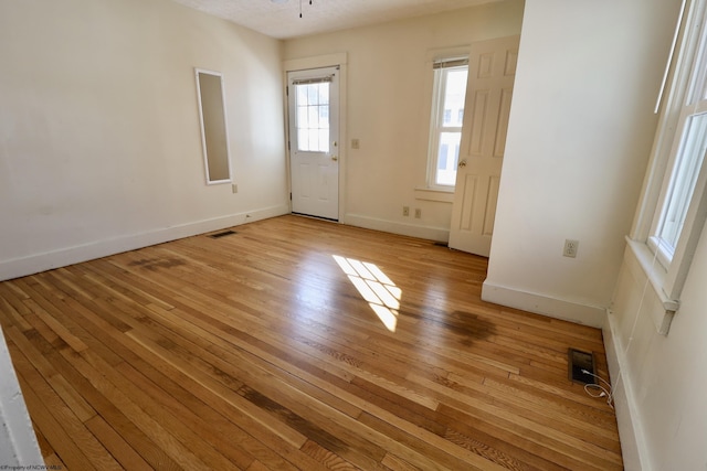 unfurnished room featuring light hardwood / wood-style floors