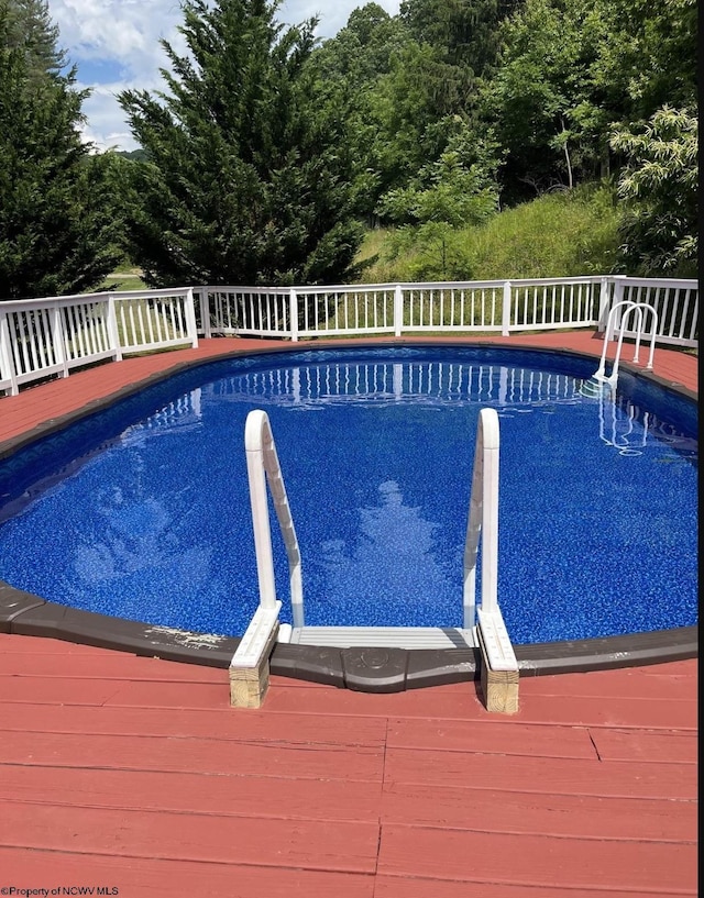 view of swimming pool featuring a wooden deck