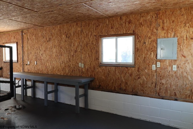 basement featuring wooden ceiling and electric panel