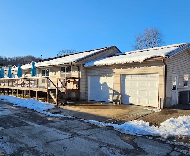 exterior space featuring a garage and a deck