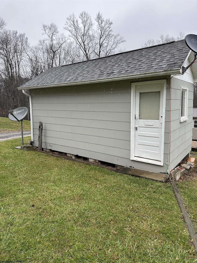 view of side of home with a yard