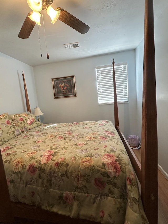 bedroom with wood-type flooring and ceiling fan