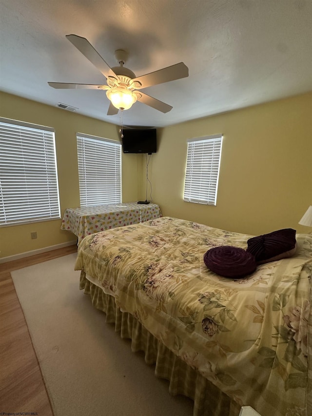 bedroom with hardwood / wood-style flooring and ceiling fan