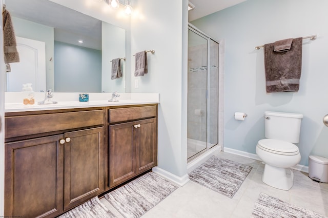 bathroom featuring tile patterned flooring, toilet, vanity, and walk in shower