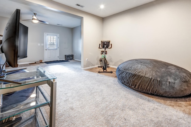 living area featuring ceiling fan and carpet floors