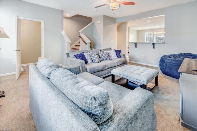 carpeted living room with ceiling fan