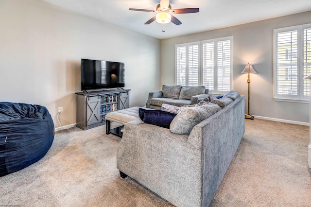 carpeted living room with ceiling fan