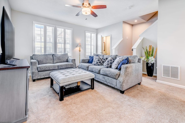 living room with light colored carpet and ceiling fan