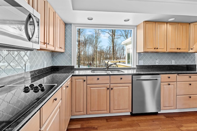 kitchen with appliances with stainless steel finishes, sink, dark wood-type flooring, and light brown cabinets