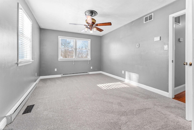 spare room with a baseboard radiator, ceiling fan, and carpet flooring