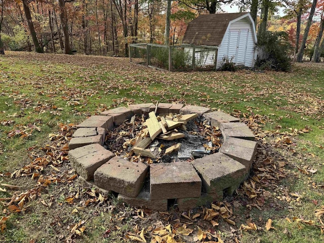 view of yard with an outdoor fire pit and a shed