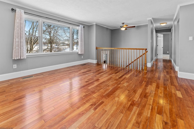 unfurnished room with ornamental molding, hardwood / wood-style floors, and ceiling fan