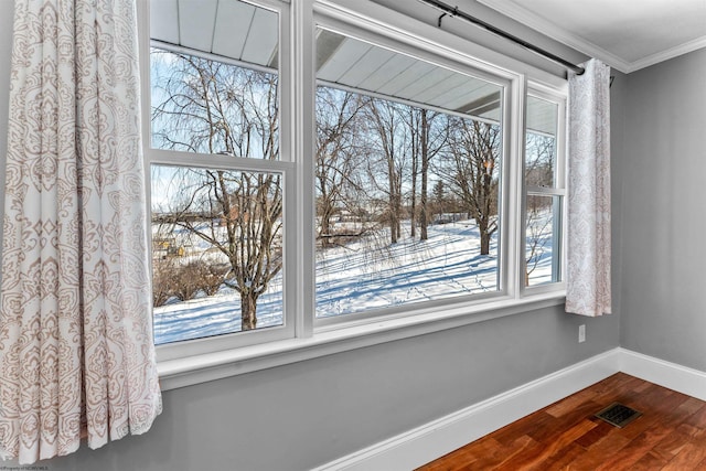 details with ornamental molding and hardwood / wood-style floors