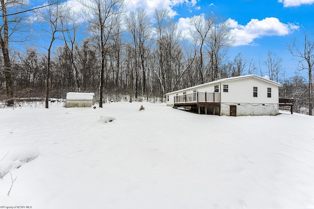 exterior space featuring a deck and a shed