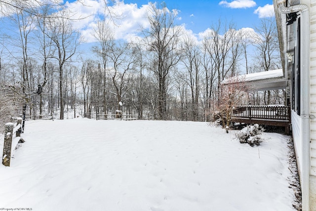 snowy yard with a deck