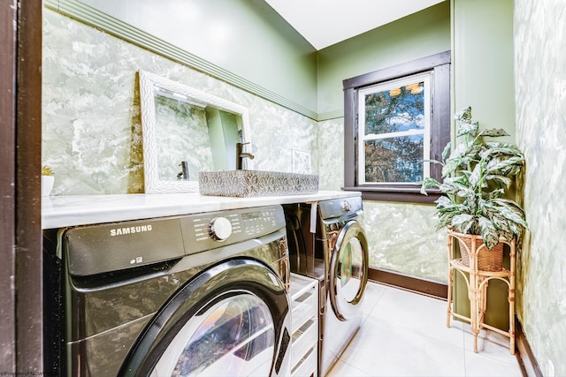 laundry area with light tile patterned floors and independent washer and dryer