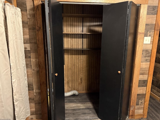 hallway featuring wood walls