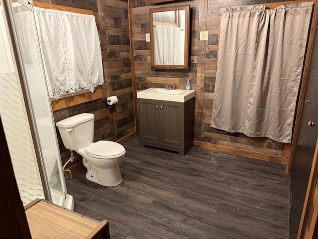 bathroom featuring vanity, toilet, and wood-type flooring