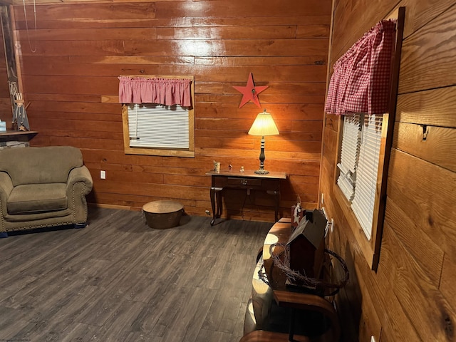 living area featuring wood-type flooring and wood walls