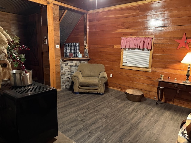 sitting room with hardwood / wood-style flooring and wood walls