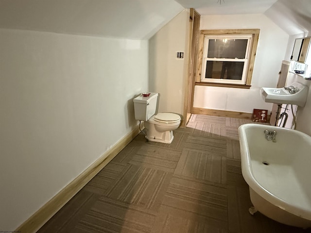 bathroom featuring a tub and toilet