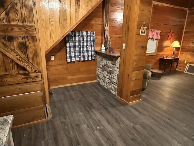 bar featuring wooden walls and dark hardwood / wood-style flooring