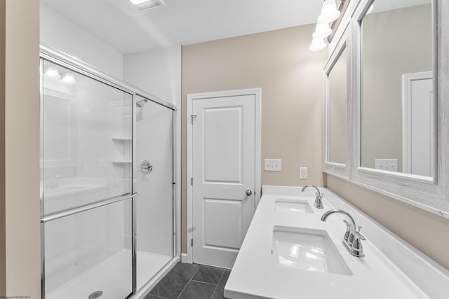 bathroom featuring tile patterned flooring, vanity, and a shower with door