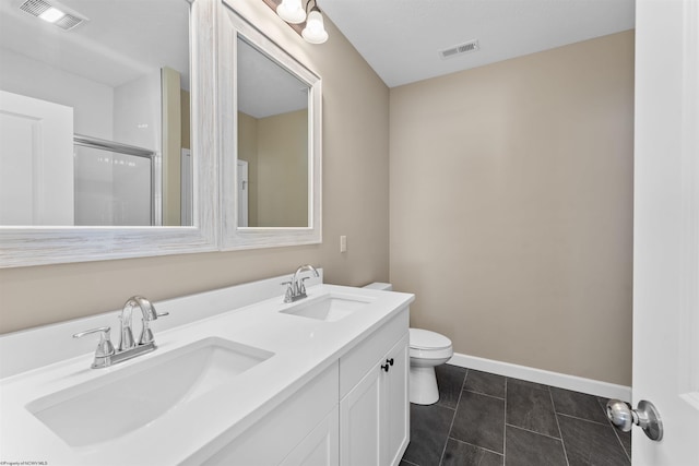 bathroom featuring an enclosed shower, vanity, tile patterned floors, and toilet