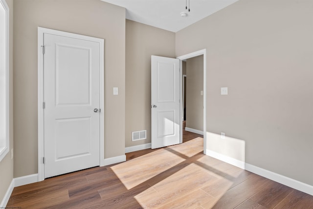 unfurnished bedroom with wood-type flooring